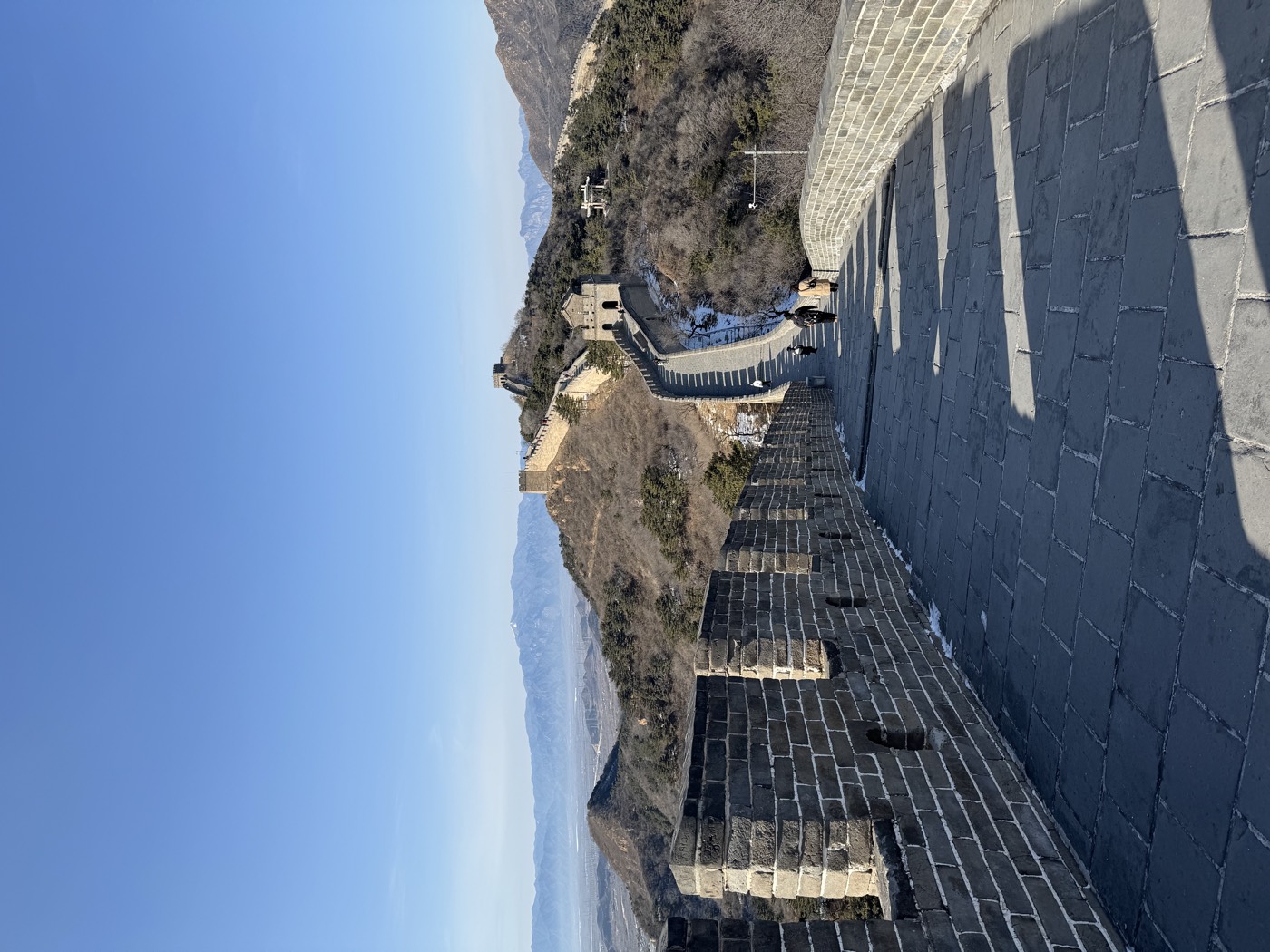 A stretch of the Great Wall of China winding over the mountains under a clear winter sky near Beijing.
